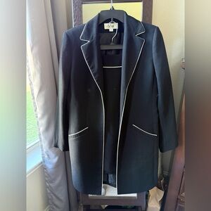 Women's Black Skirt Suit with White Trim.